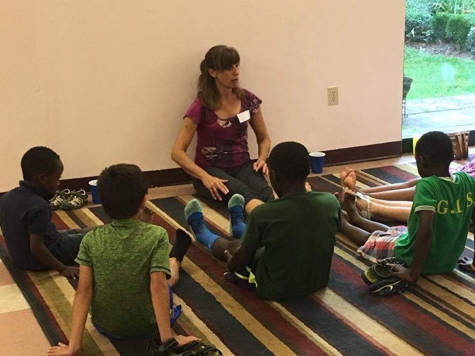 Woman Leading a Seated Group Lesson on A Striped Rug — Amherst, MA — Immanuel Lutheran Church