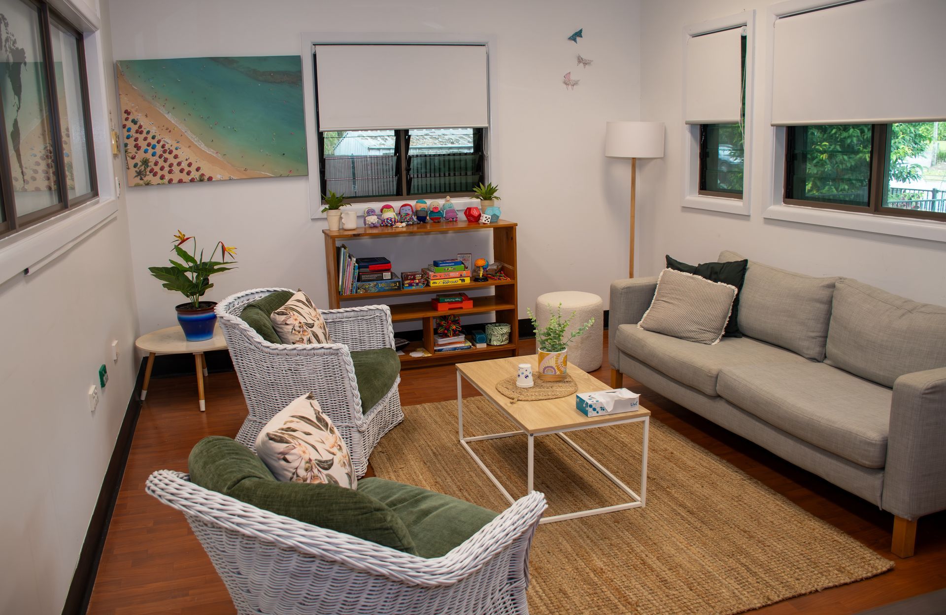 A living room with a couch , chairs , and a coffee table.