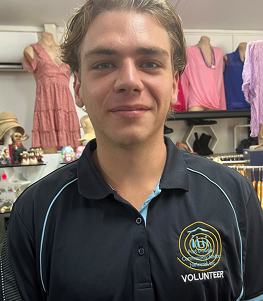 A young man wearing a black shirt that says volunteer