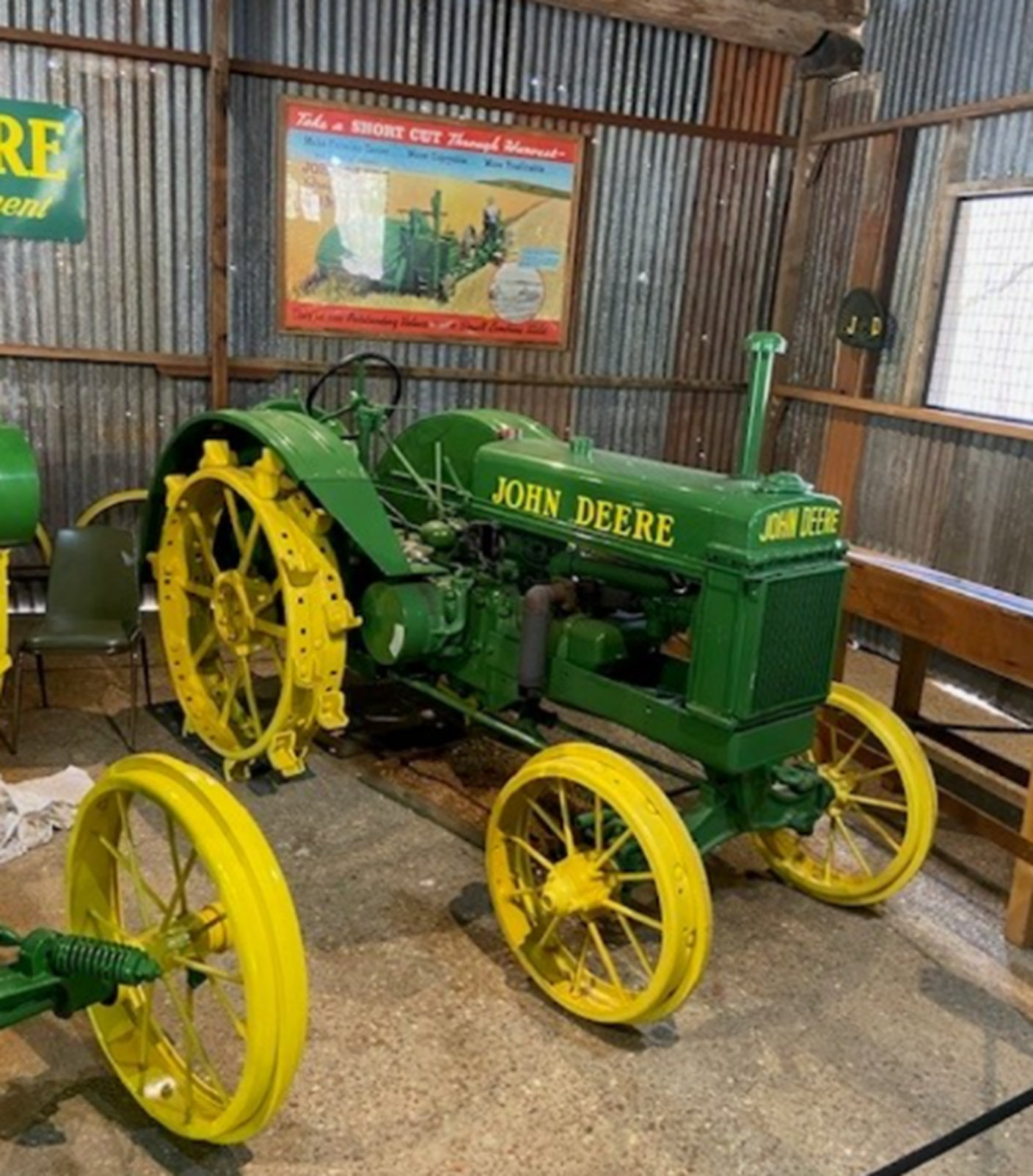 A green john deere tractor with yellow wheels