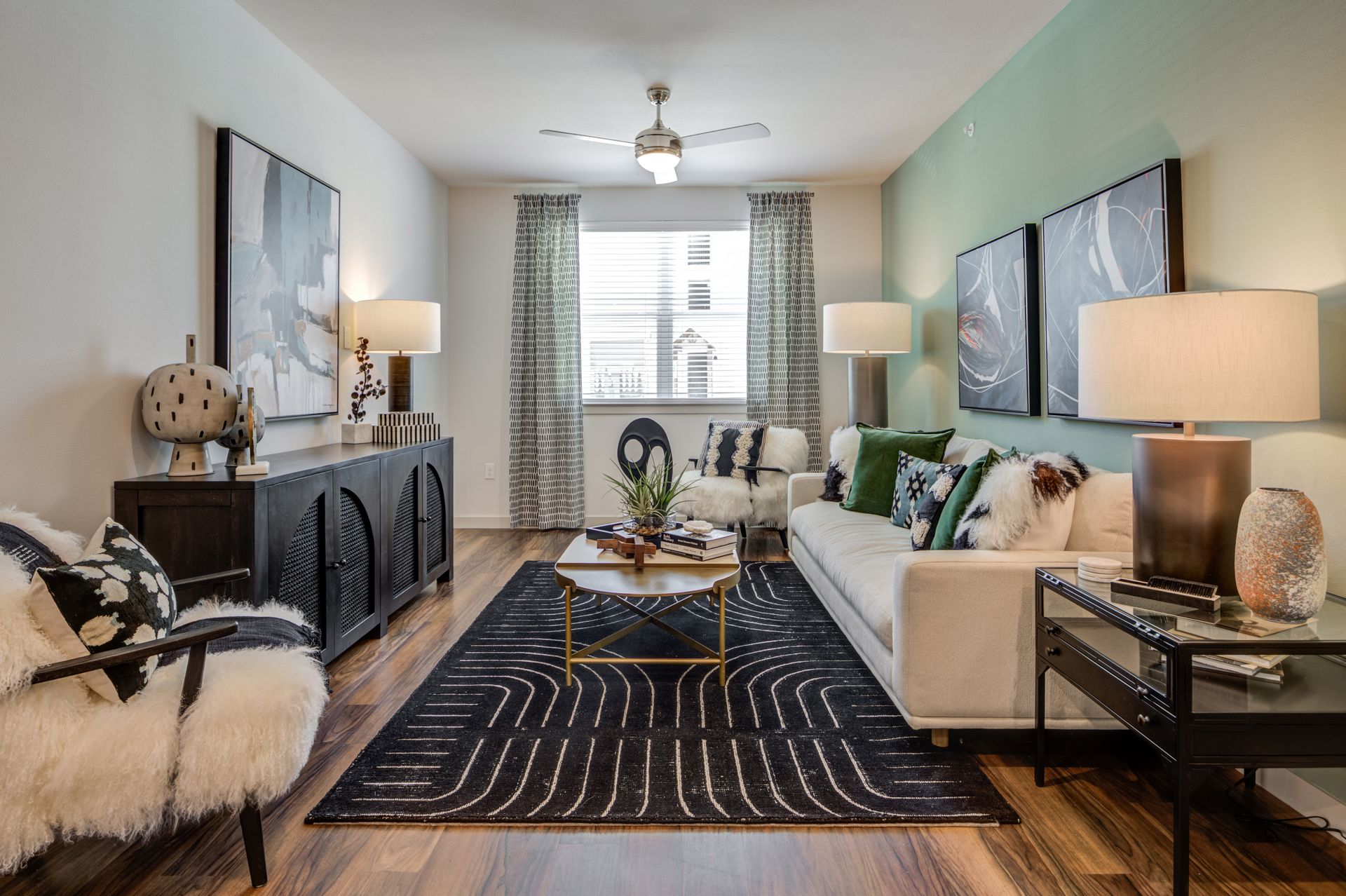A living room with a couch , chairs , lamps and a rug at The Jameson.