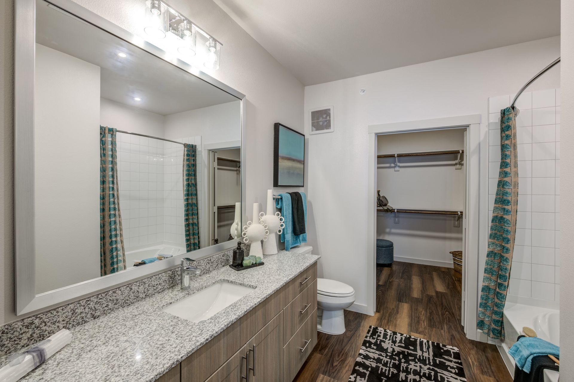 A bathroom with two sinks , a toilet , and a walk in closet at The Jameson.