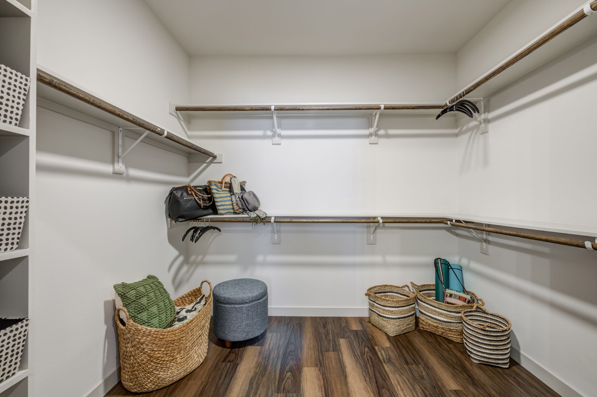 A walk in closet with lots of shelves and baskets at The Jameson.