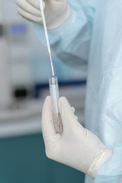 person pricking their finger