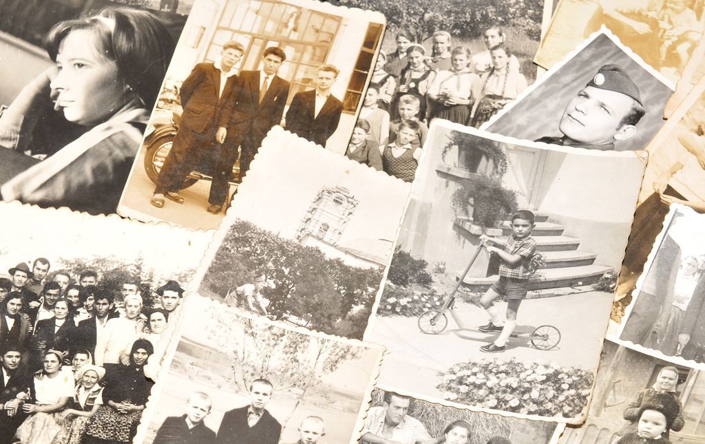Collage of vintage black-and-white photos scattered on a beige background