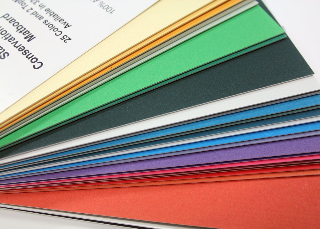 Stacked colorful swatches or material samples fanned out in a diagonal row