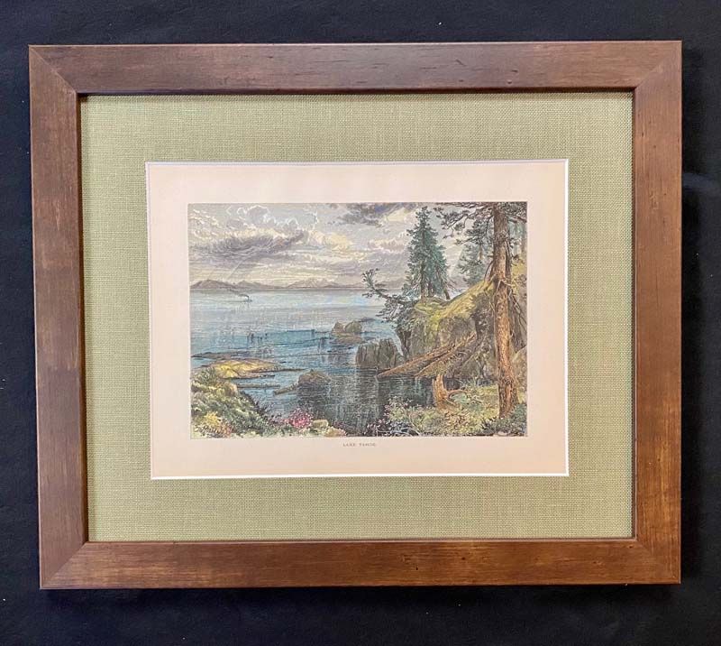 Framed landscape painting with a lake, mountains, and trees in muted colors