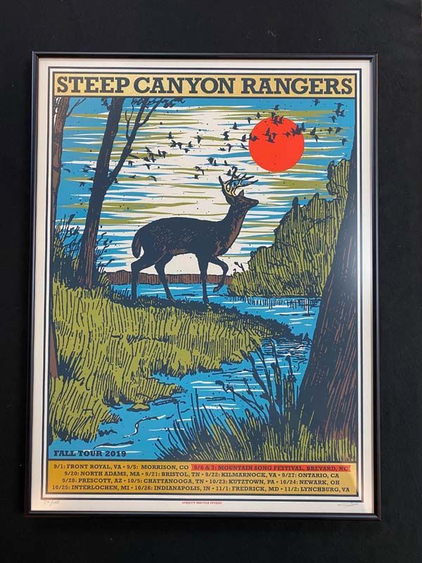 Vintage poster of a deer by a blue river at sunset, titled “Steep Canyon Rangers.”
