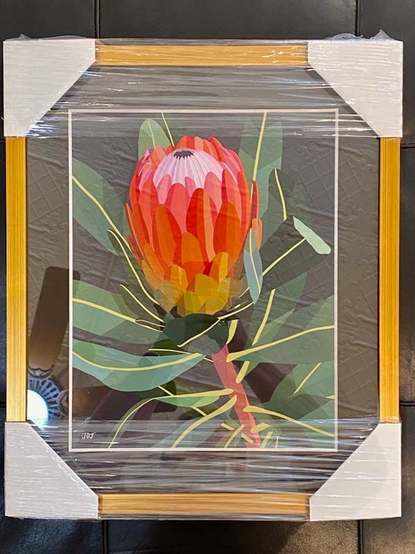 Framed abstract painting of a red-orange flower with green leaves on a dark background