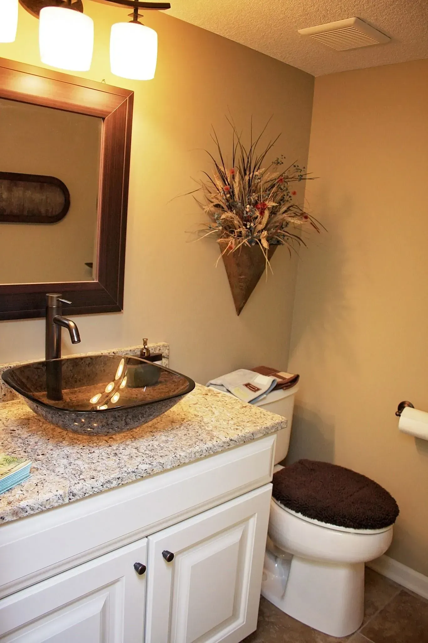 A bathroom with a sink , toilet and mirror