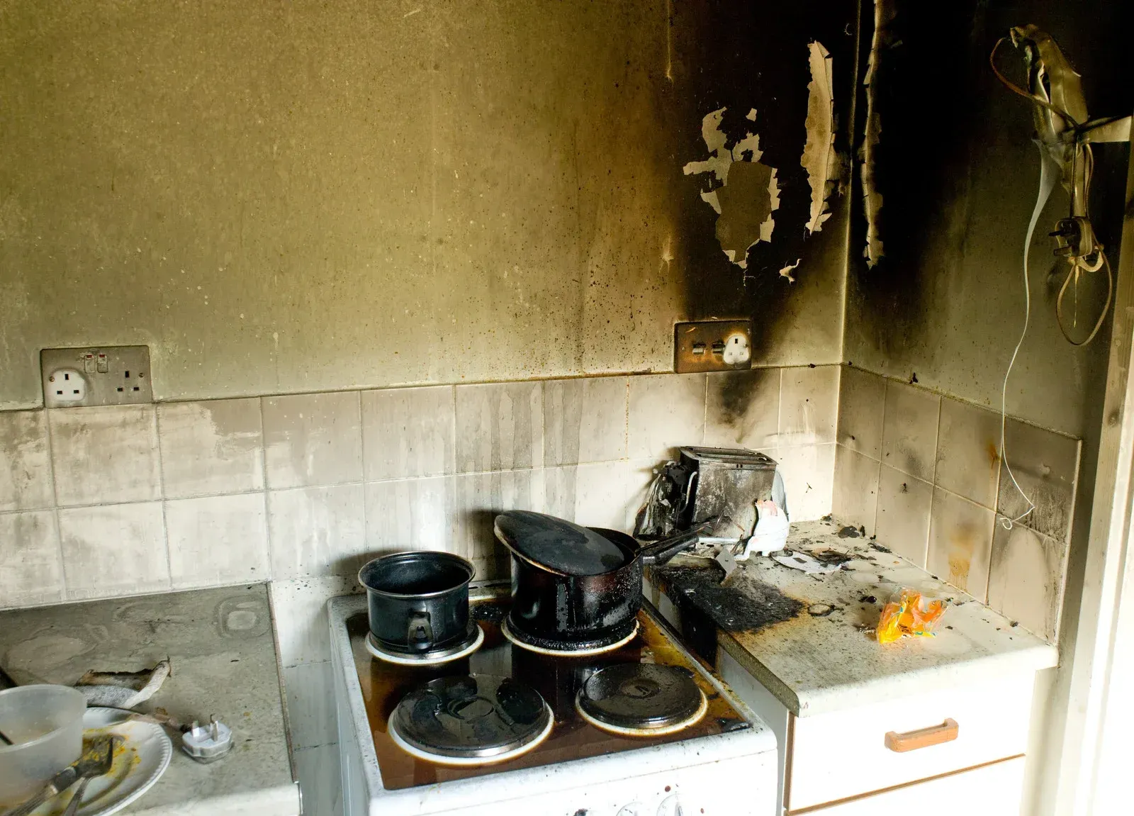 A kitchen with pots and pans on the stove top