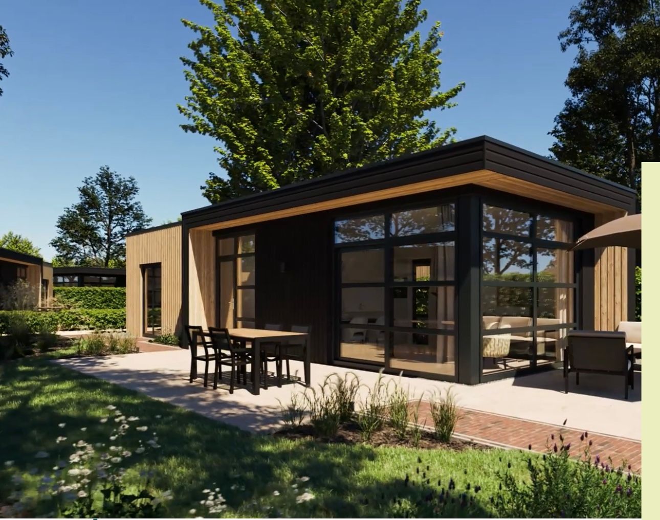 Een stenen huisje in een bosrijk gebied met een grindpad en herfstkleuren.