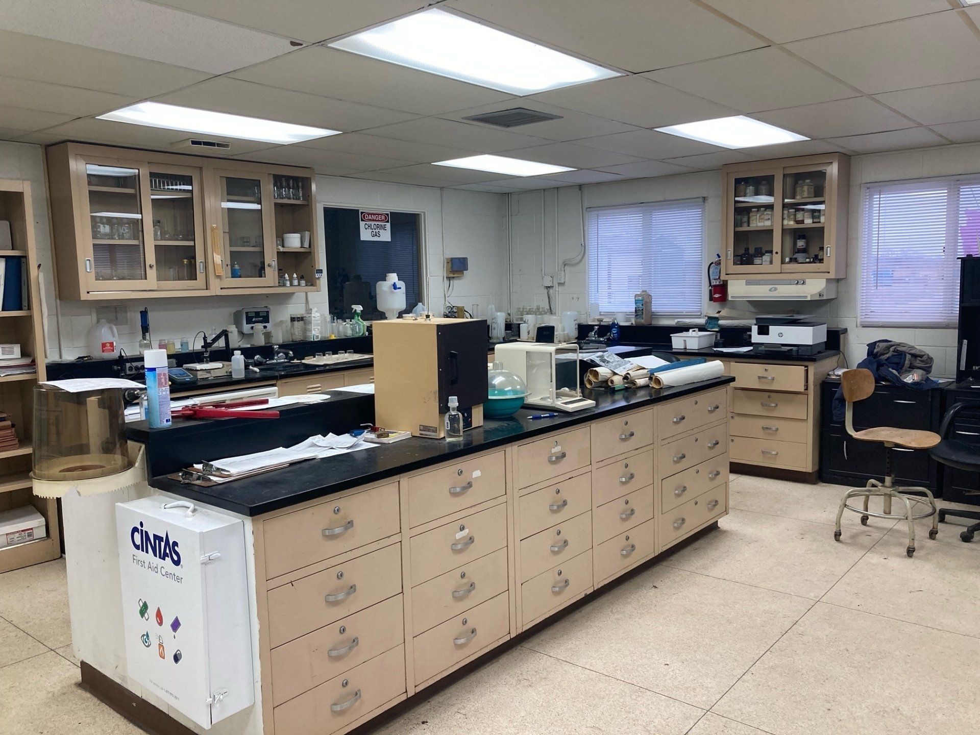 A laboratory with a long counter and a box that says cards on it