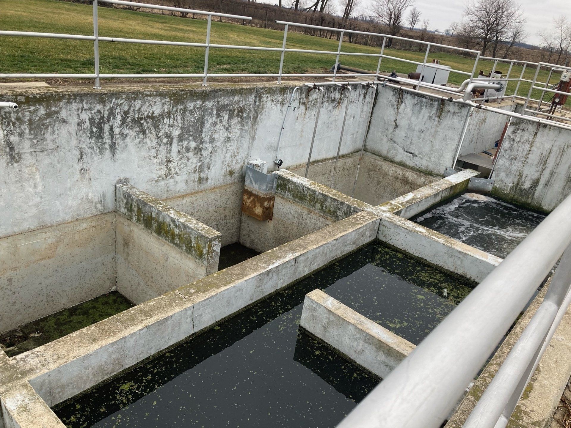 A large concrete tank filled with a lot of water
