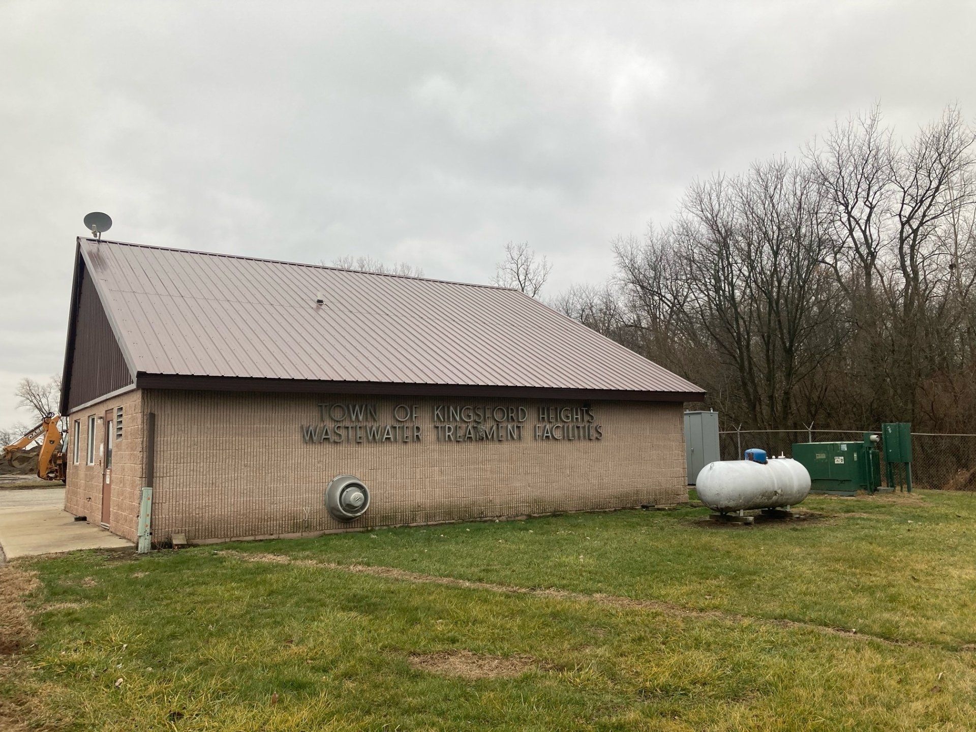 A building with a propane tank in front of it.