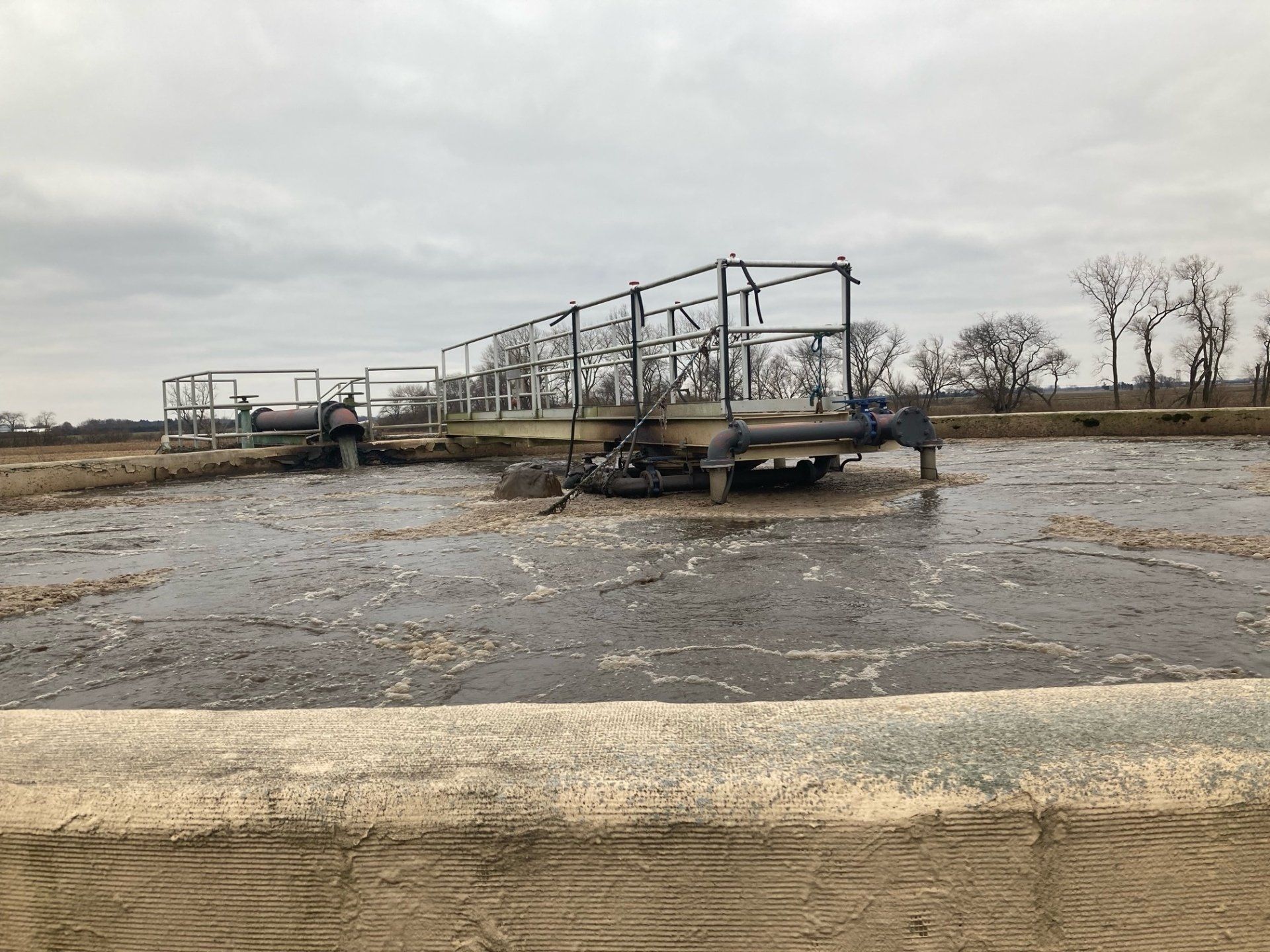A large body of water with a bridge in the middle of it.