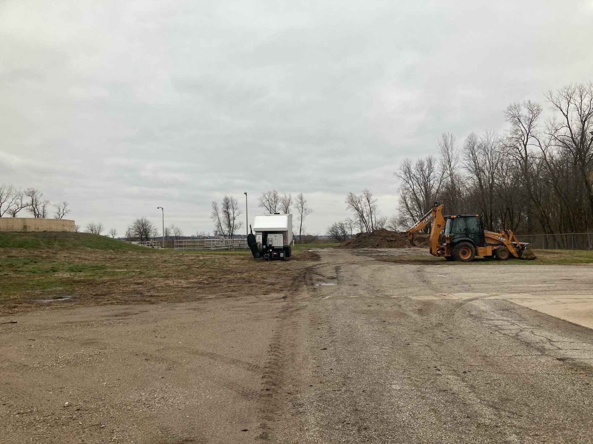 A bulldozer is parked in the middle of a dirt road.