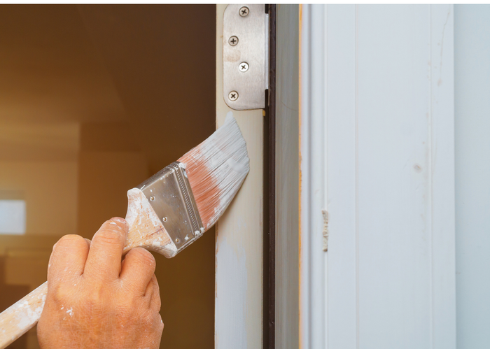 Painting door and trip of a house in College Station, Texas