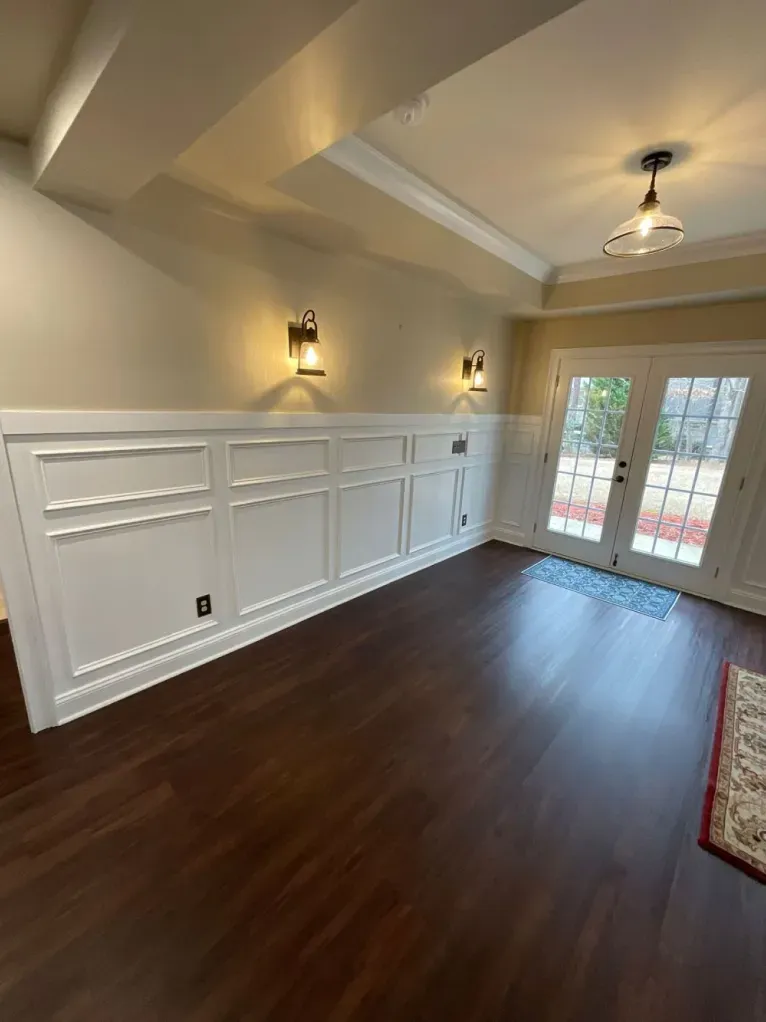 A living room with hardwood floors and a french door.