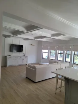 A living room with a couch and a television on the wall