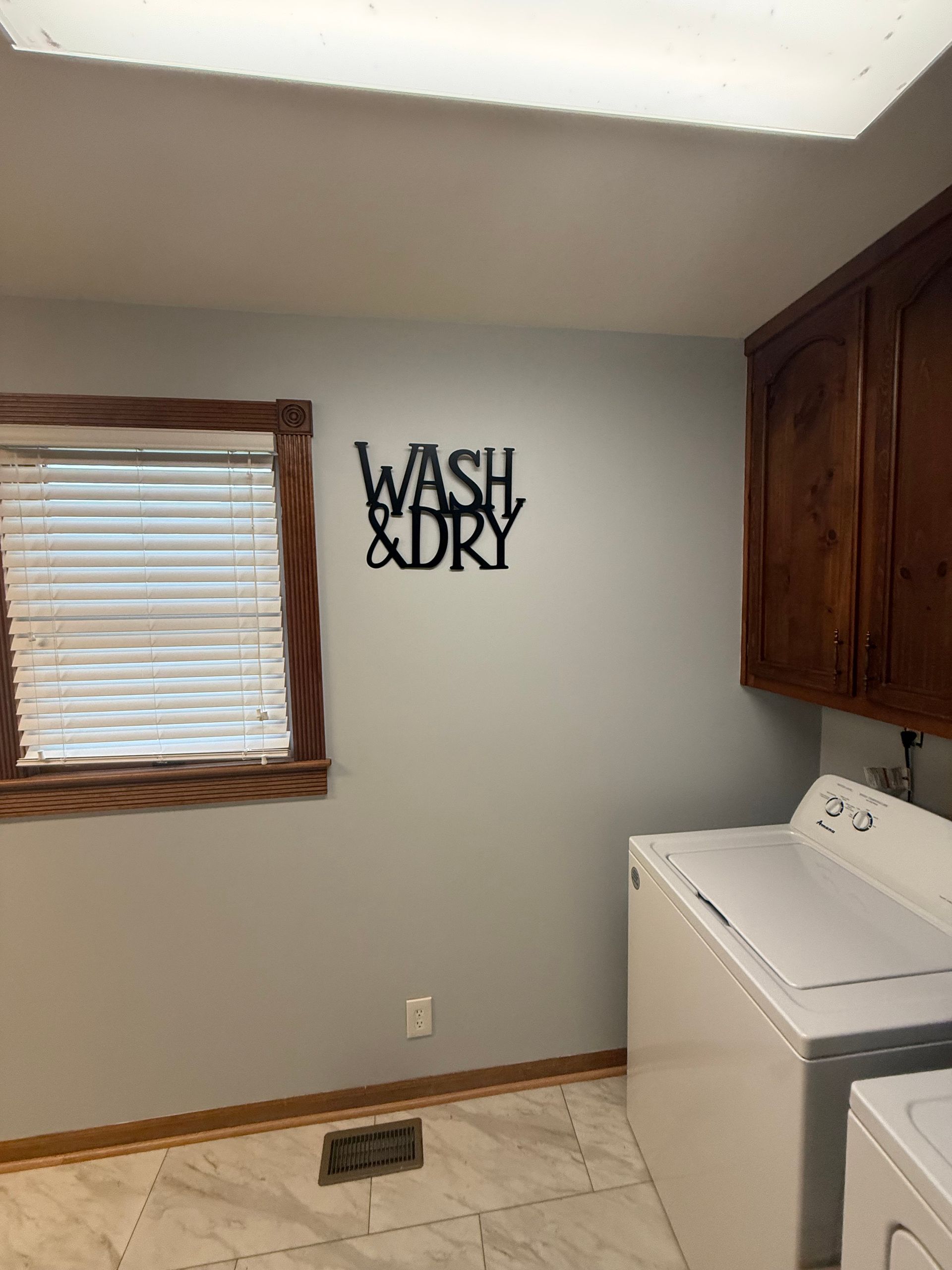 Laundry room with a washing machine, dryer, and a