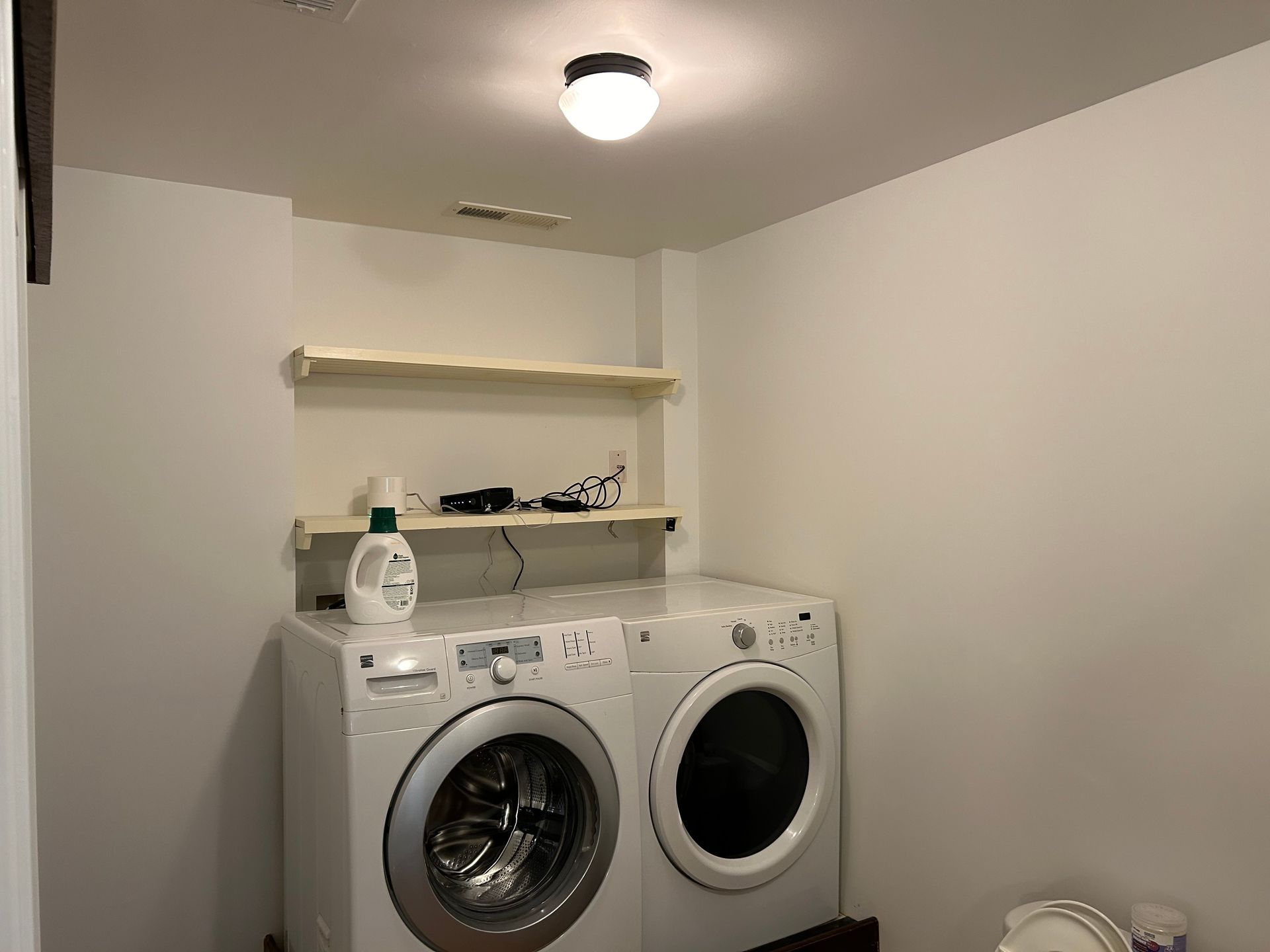 A laundry room with a washer and dryer and a toilet.