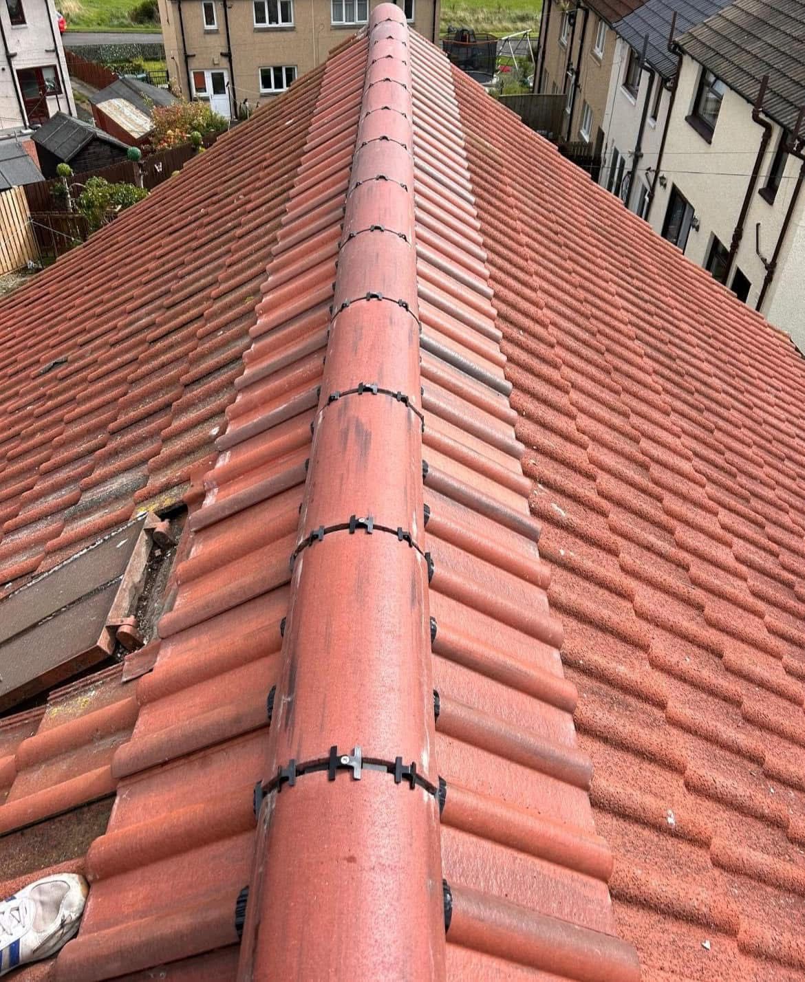A person is standing on the roof of a building.