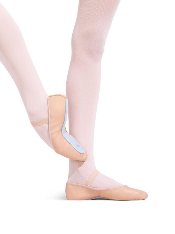 A close up of a person wearing a pair of ballet shoes.