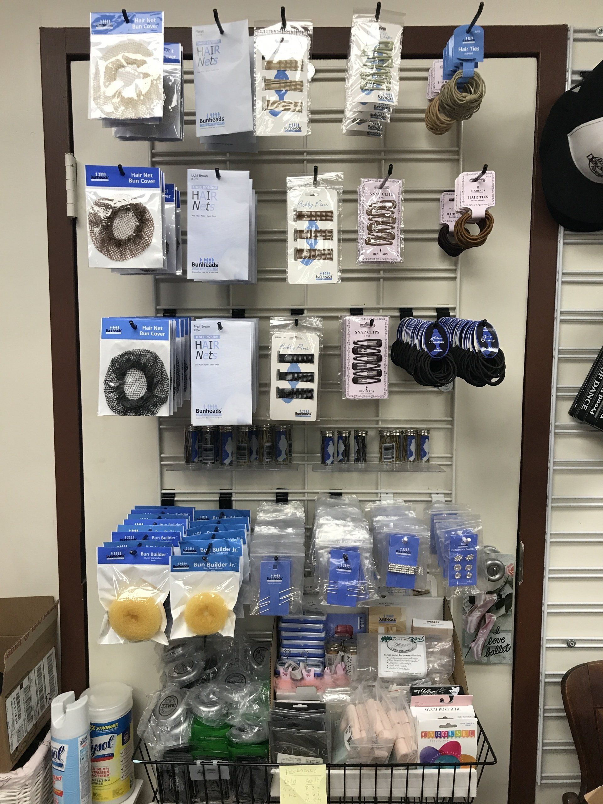 A display of hair accessories hanging on a wall in a store.