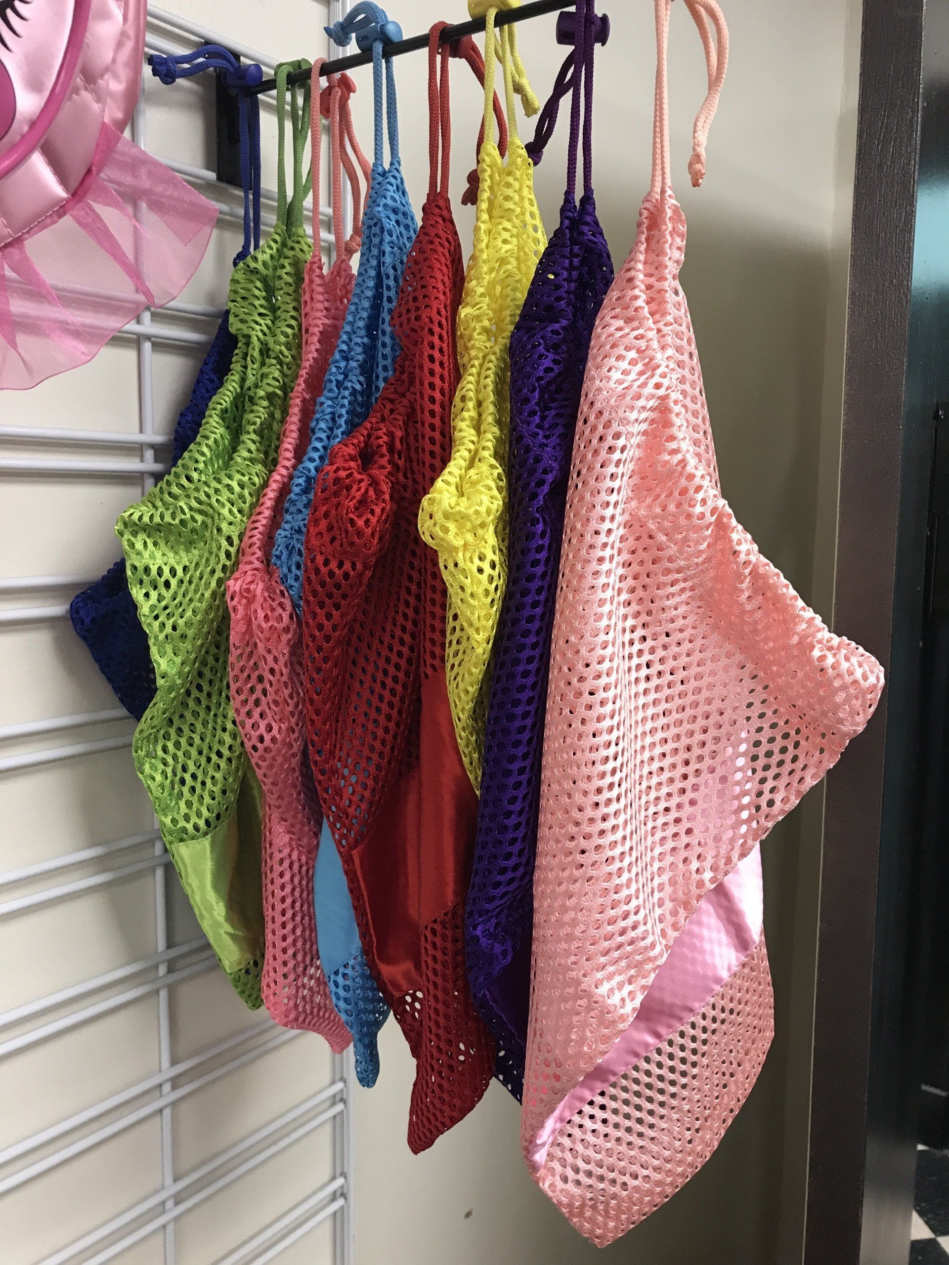 A bunch of colorful clothes hanging on a rack