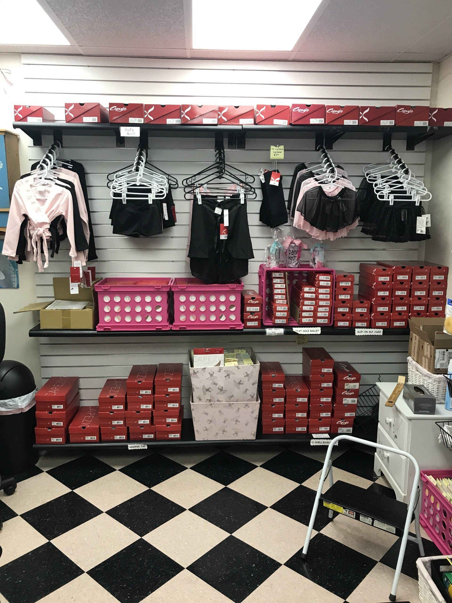 A store with a checkered floor and shelves full of clothes