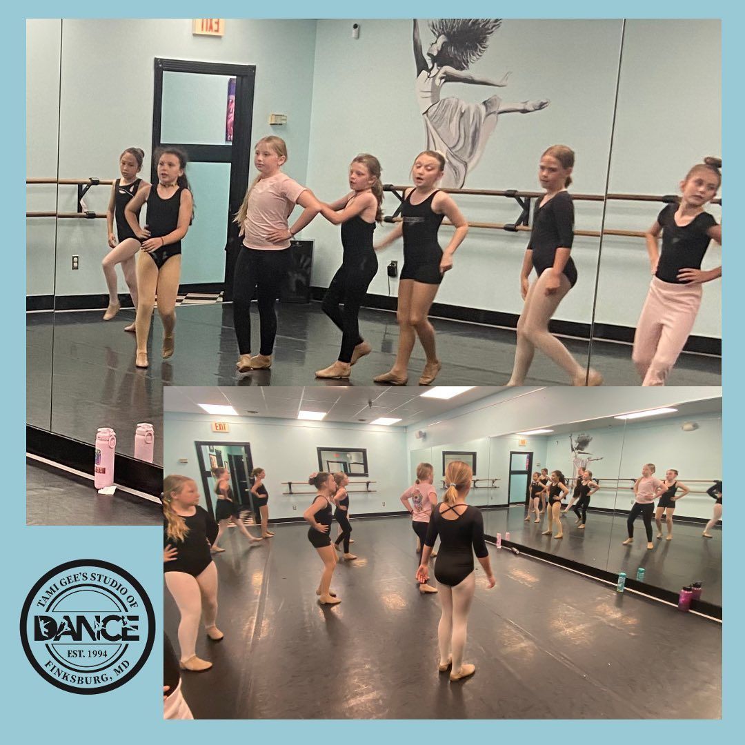 A group of young girls are dancing in a dance studio