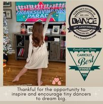 A young girl is standing in front of a television in a living room.