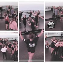 A group of people are dancing in a dance studio.