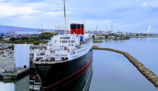 Queen Mary ship in Long Beach, CA. Presented by the BusPartyLA.com Side view of Queen Mary in Long Beach presented by party bus rentals Long Beach.