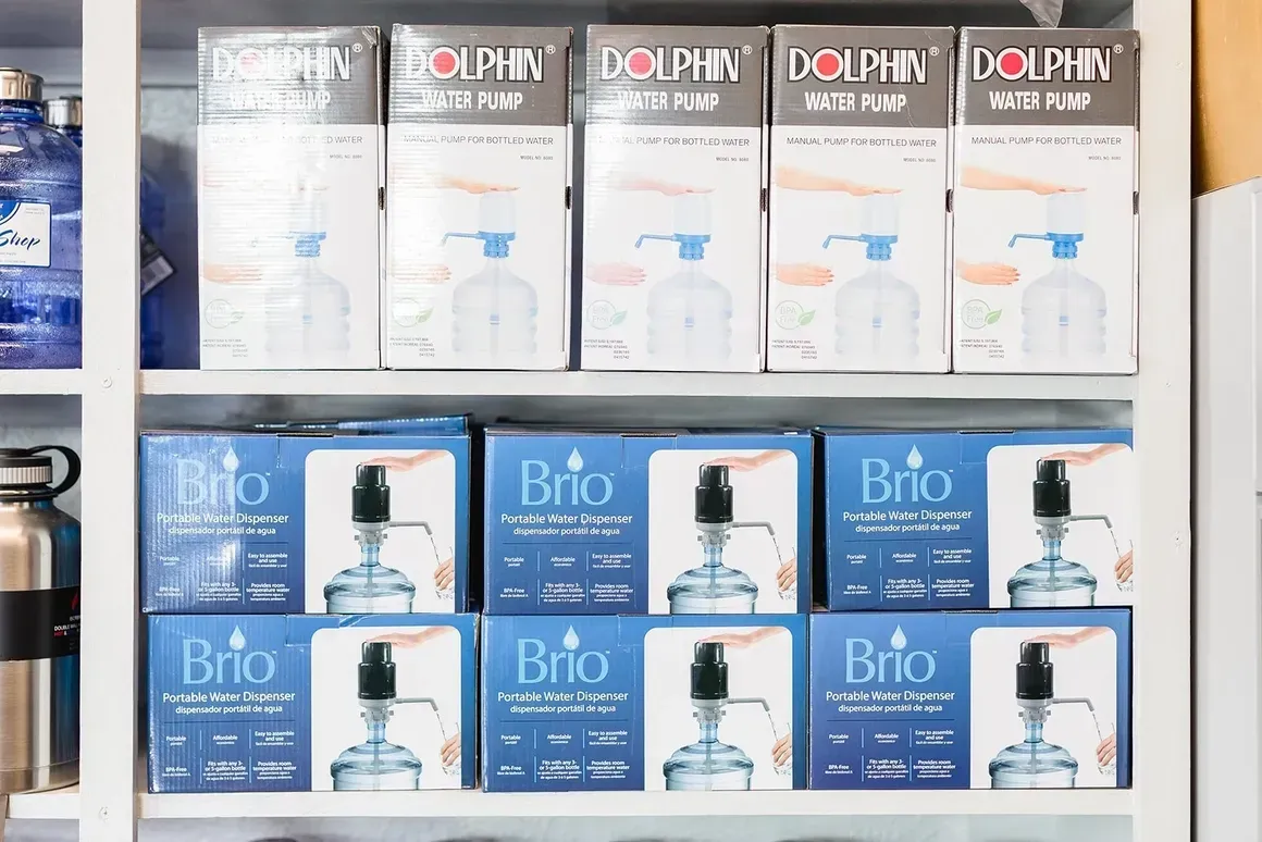 A shelf filled with boxes of dolphin water pumps.