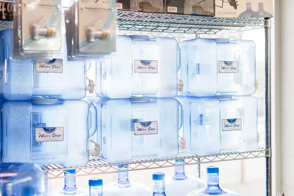 A refrigerator filled with lots of water bottles.