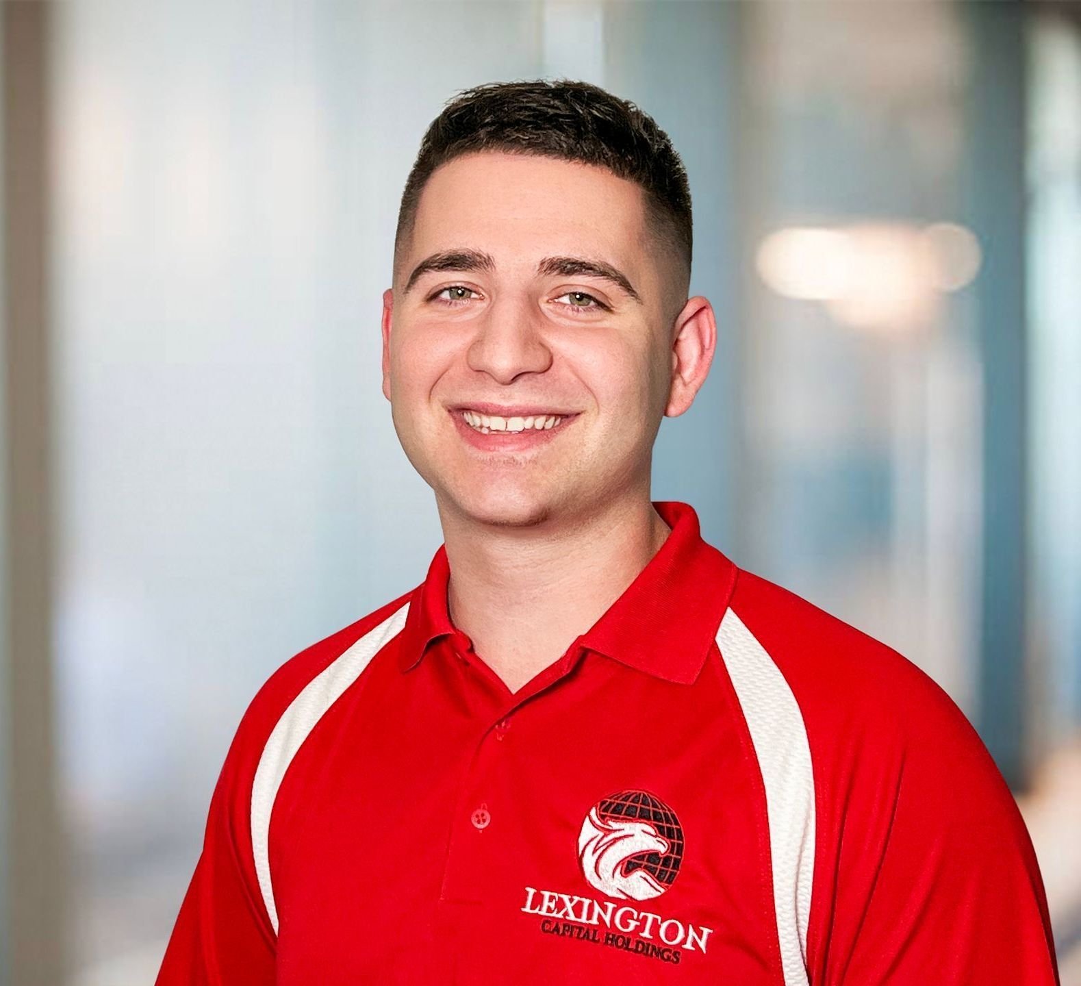 Smiling man in red polo shirt with Lexington Clinic logo.