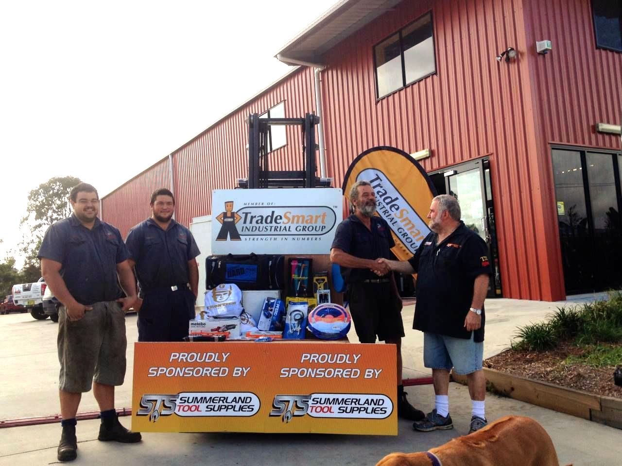 A Group of Men Standing in Front of a Tradesmart Sign — Summerland Tool Supplies In Casino, NSW