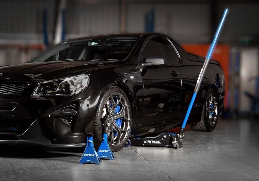 A Black Car is Parked in a Garage Next to a Jack— Summerland Tool Supplies in Casino, NSW