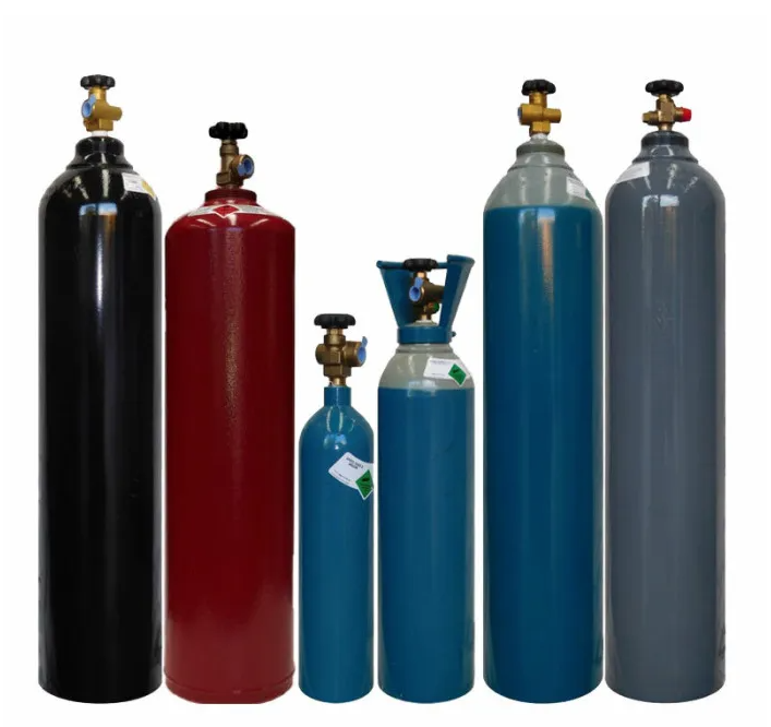 A group of gas cylinders are lined up in a row on a white background.