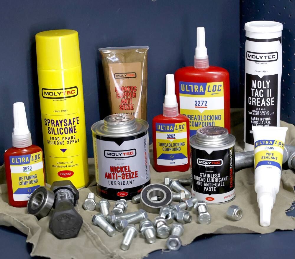 A Bottle of Spray Safe Silicone Sits Next to a Bottle of Moly Tac II Grease— Summerland Tool Supplies in Casino, NSW