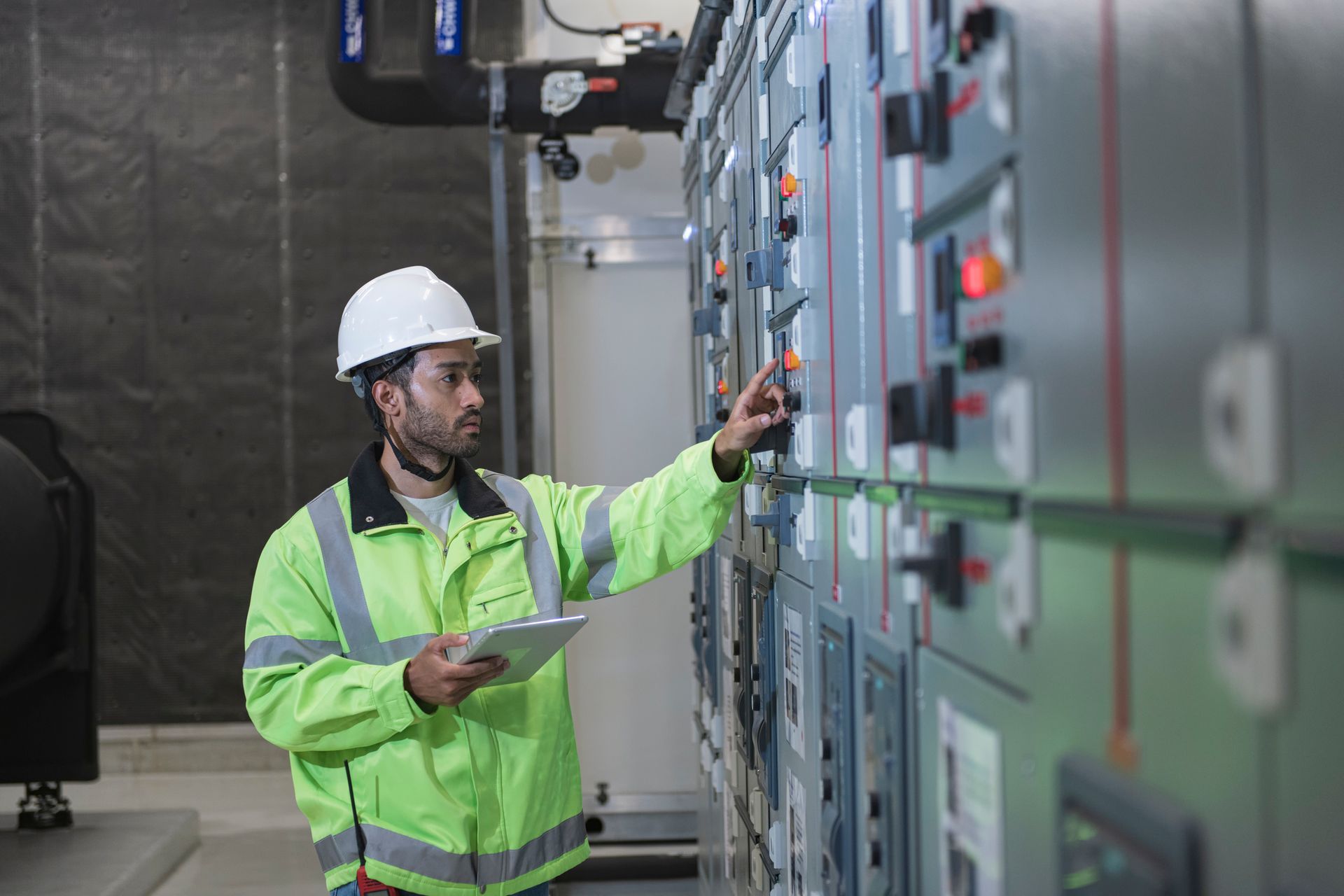 Technical worker working on switch board in Electrical station Technical worker working on switch board in Electrical station