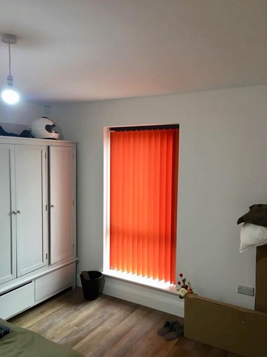 Fiery orange vertical blinds with charcoal pelmet headrails