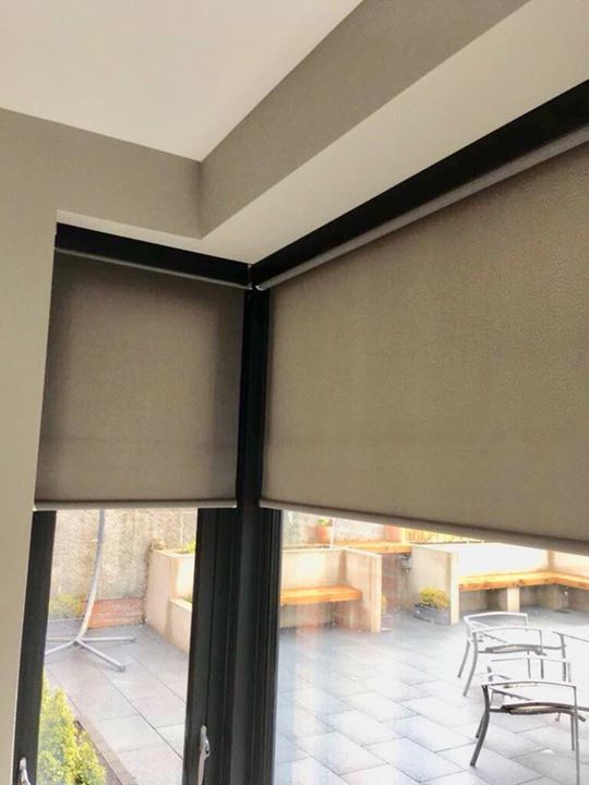 Grey roller blinds with black pelmets