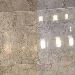 Floor polishing machine working on a light-colored surface, possibly concrete.