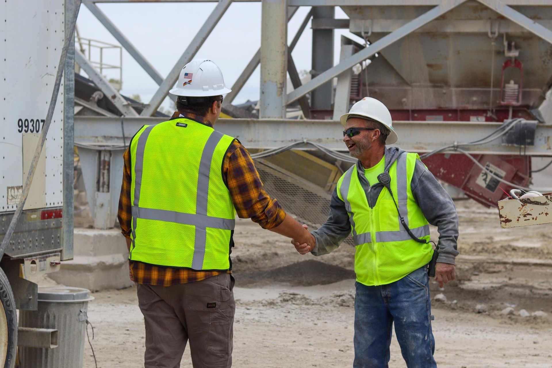 A man is sitting in the driver 's seat of a red truck.