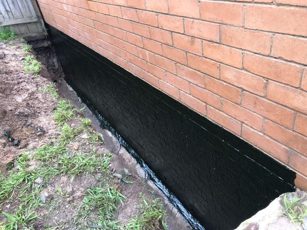 Technician sealing foundation cracks in Bradenton FL