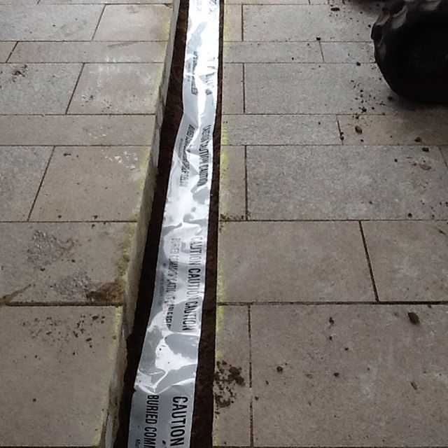 A piece of caution tape is laying on the ground