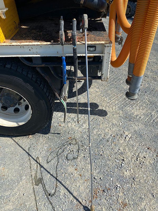 Two golf clubs are sitting on the back of a truck.